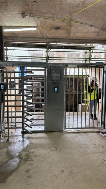 A turnstile alongside a separate pedestrian gate.