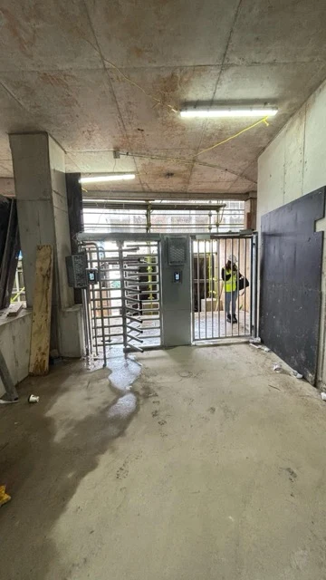The entrance positioned within a covered construction area.